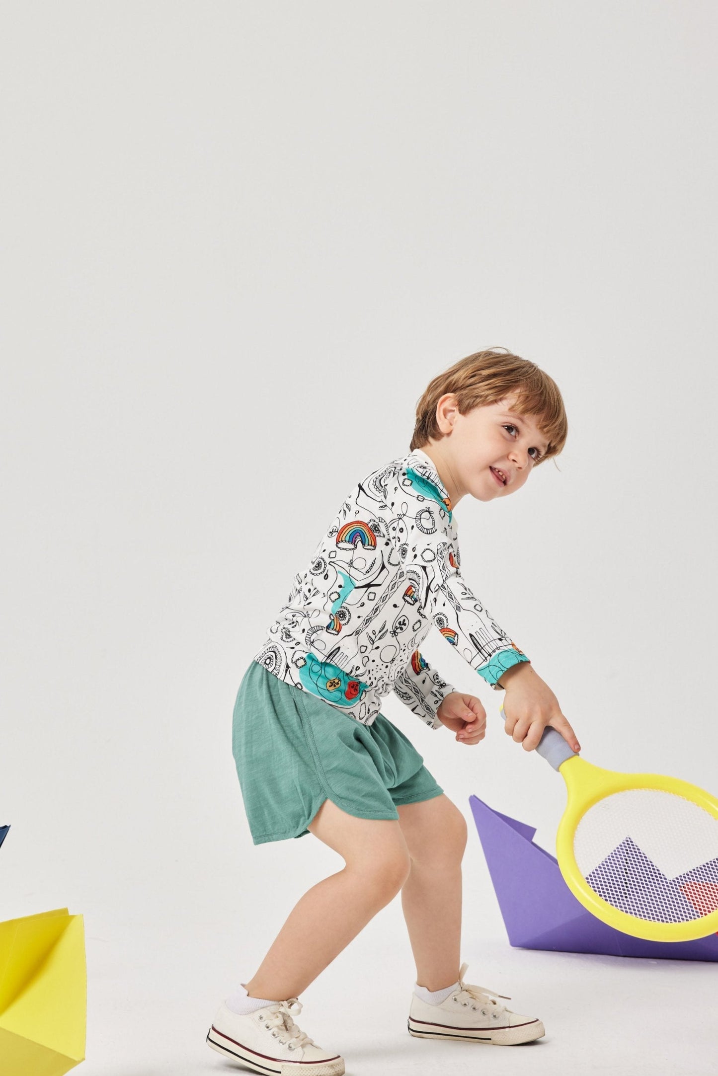 Child playing with a toy on a white background