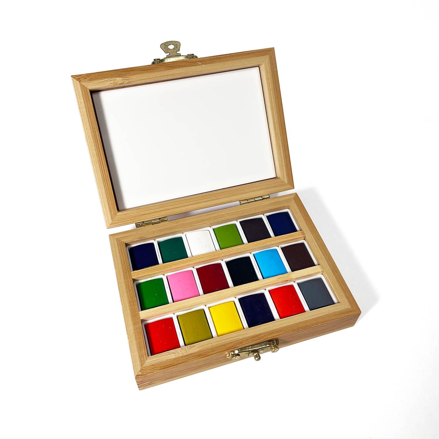 Wooden case with watercolor paints set on a white background