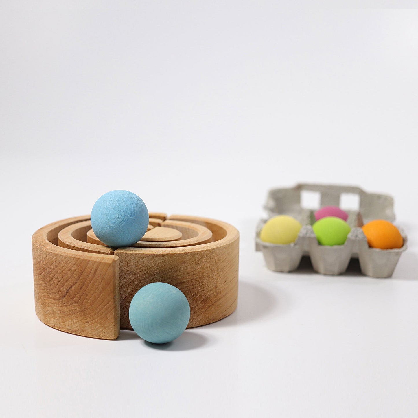 two natural arches stacked with pastel wooden balls