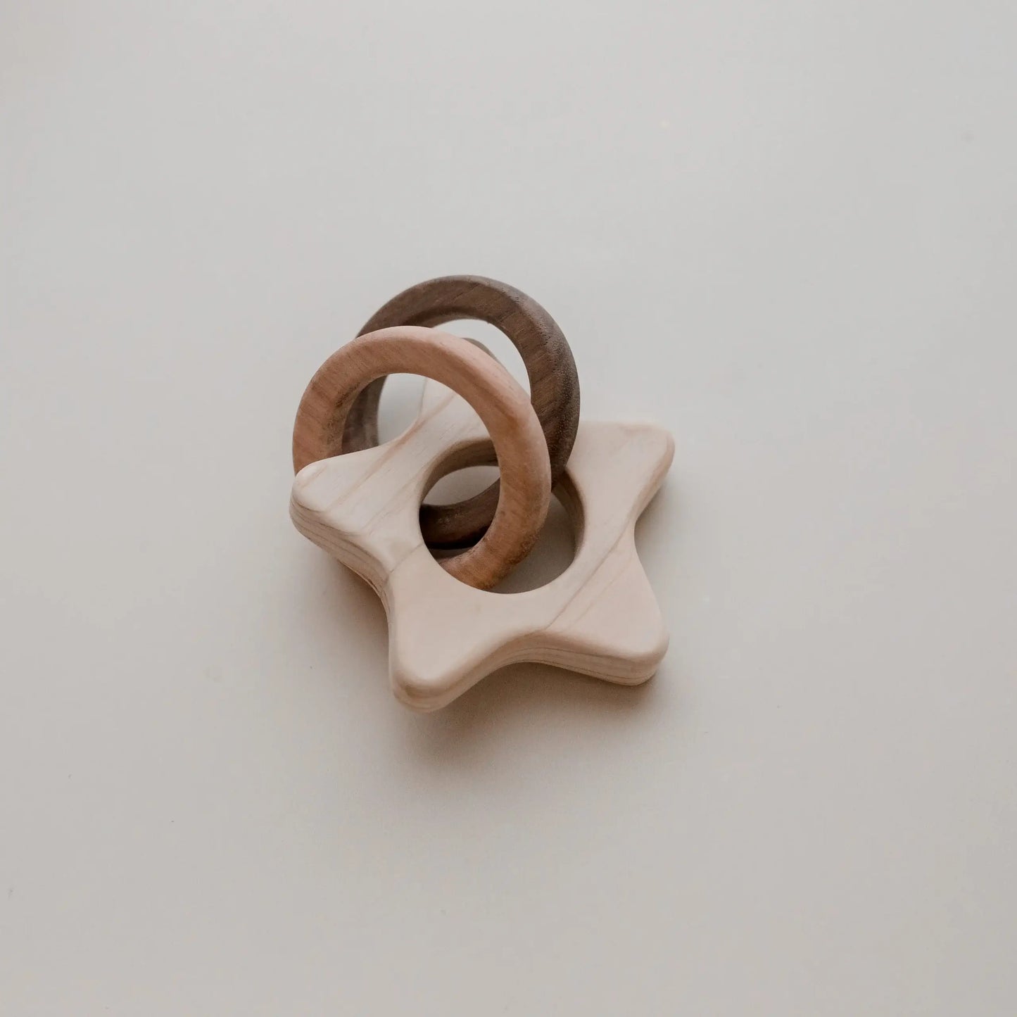 wooden star rattle with two wooden rings