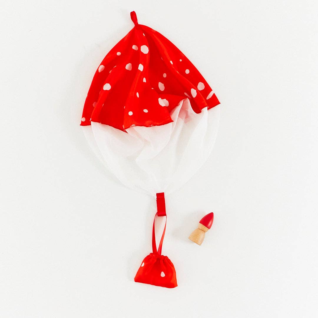 Red silk mushroom parachute on a white background