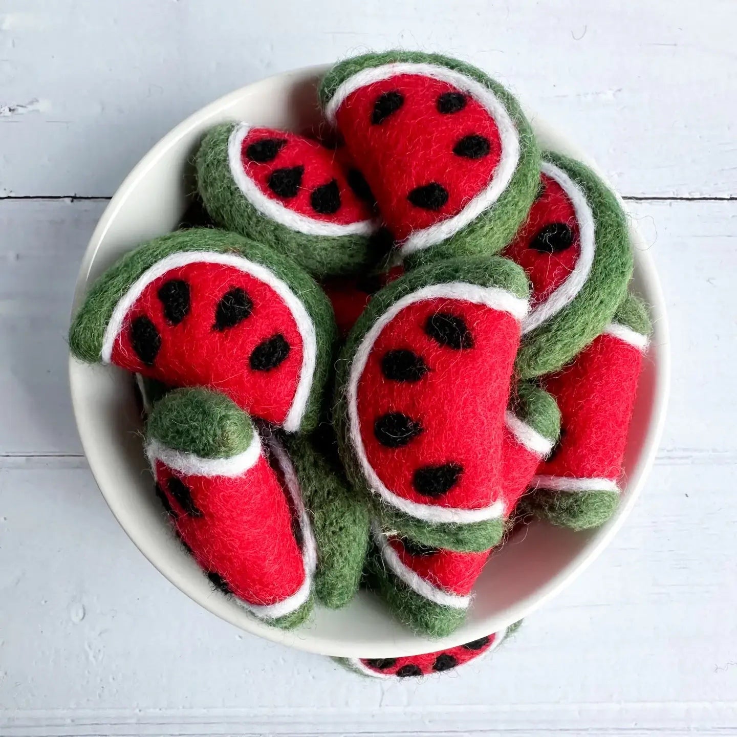 felt watermelon slices in a ceramic bowl