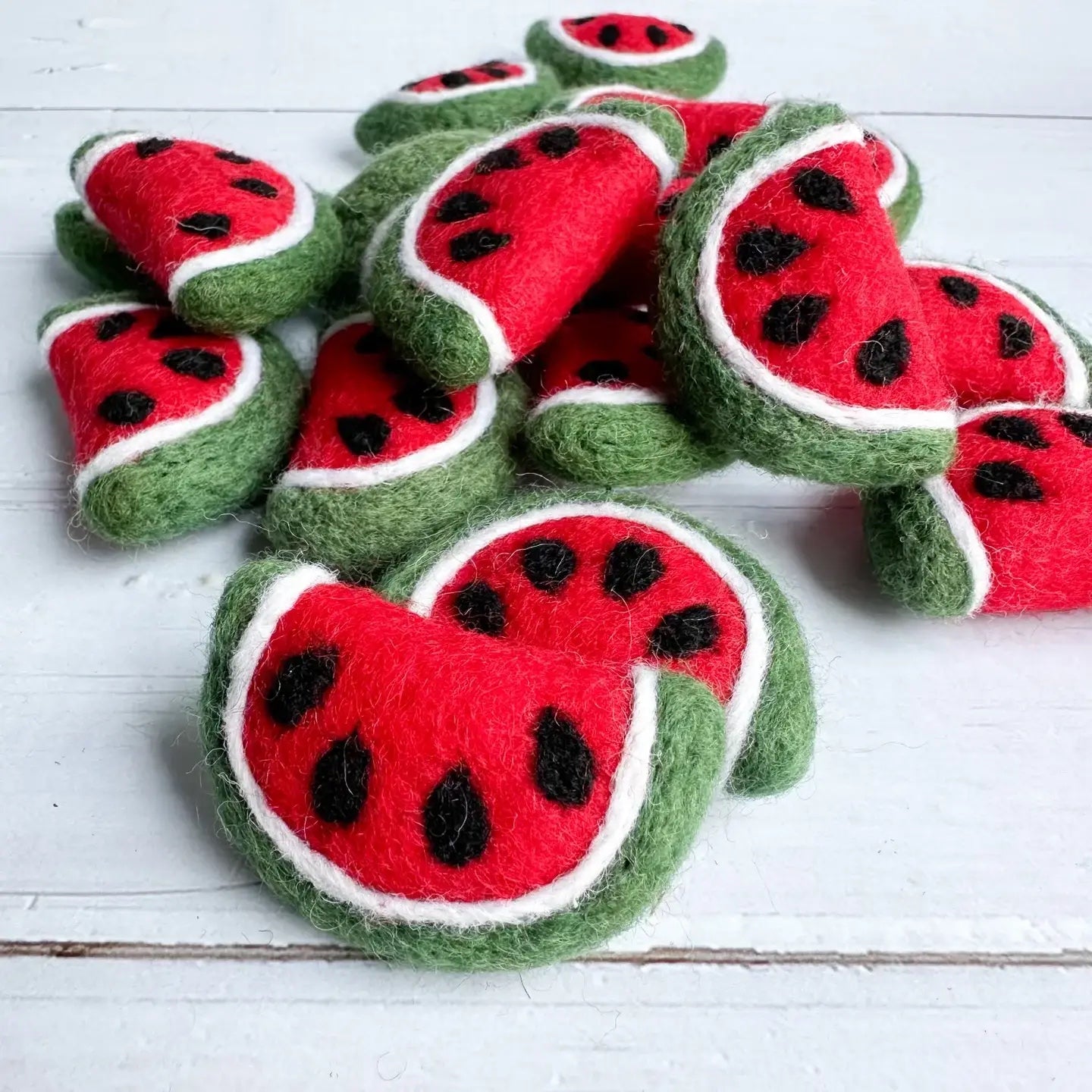 felt watermelon slices on a wooden table