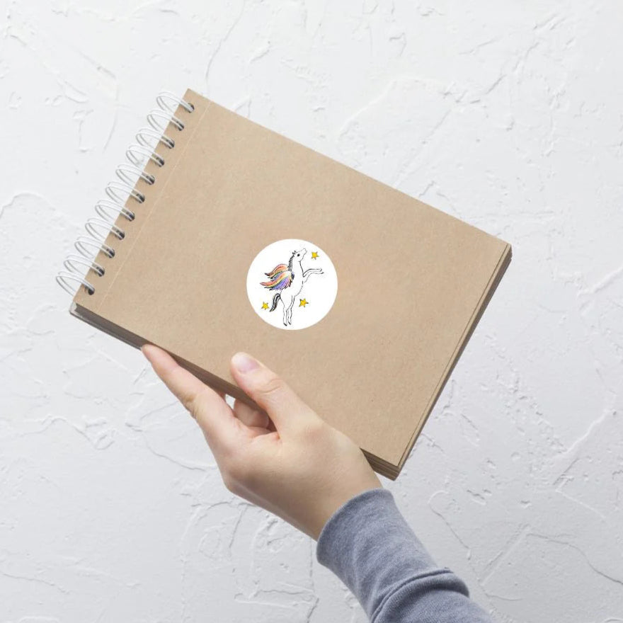rainbow pegasus sticker on a flip notebook