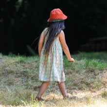 Load image into Gallery viewer, Child walking in a grass field wearing Cherries Reversible Sunhat in Olive
