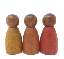 Load image into Gallery viewer, Three wooden peg people, one painted in mustard yellow, one in burnt orange, and one in red, from left to right.
