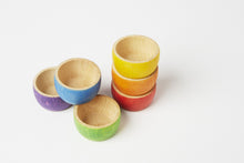 Load image into Gallery viewer, A set of six rainbow wooden bowls. From top to bottom, the yellow, orange, and red are stacked on top of each other. To the left, the purple and green are set next to each other with the purple on top
