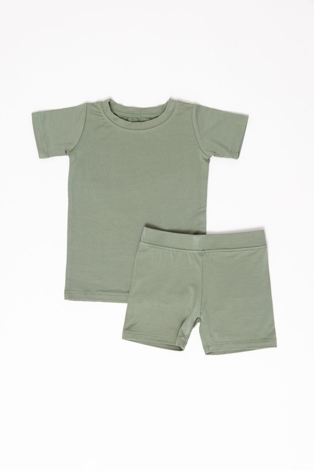 Green t-shirt and shorts set on a white background