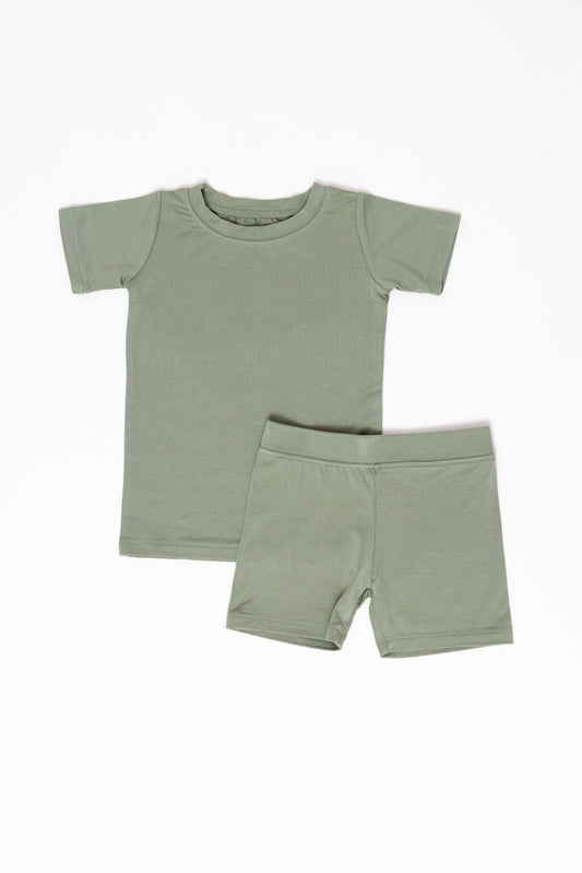 Green t-shirt and shorts set on a white background