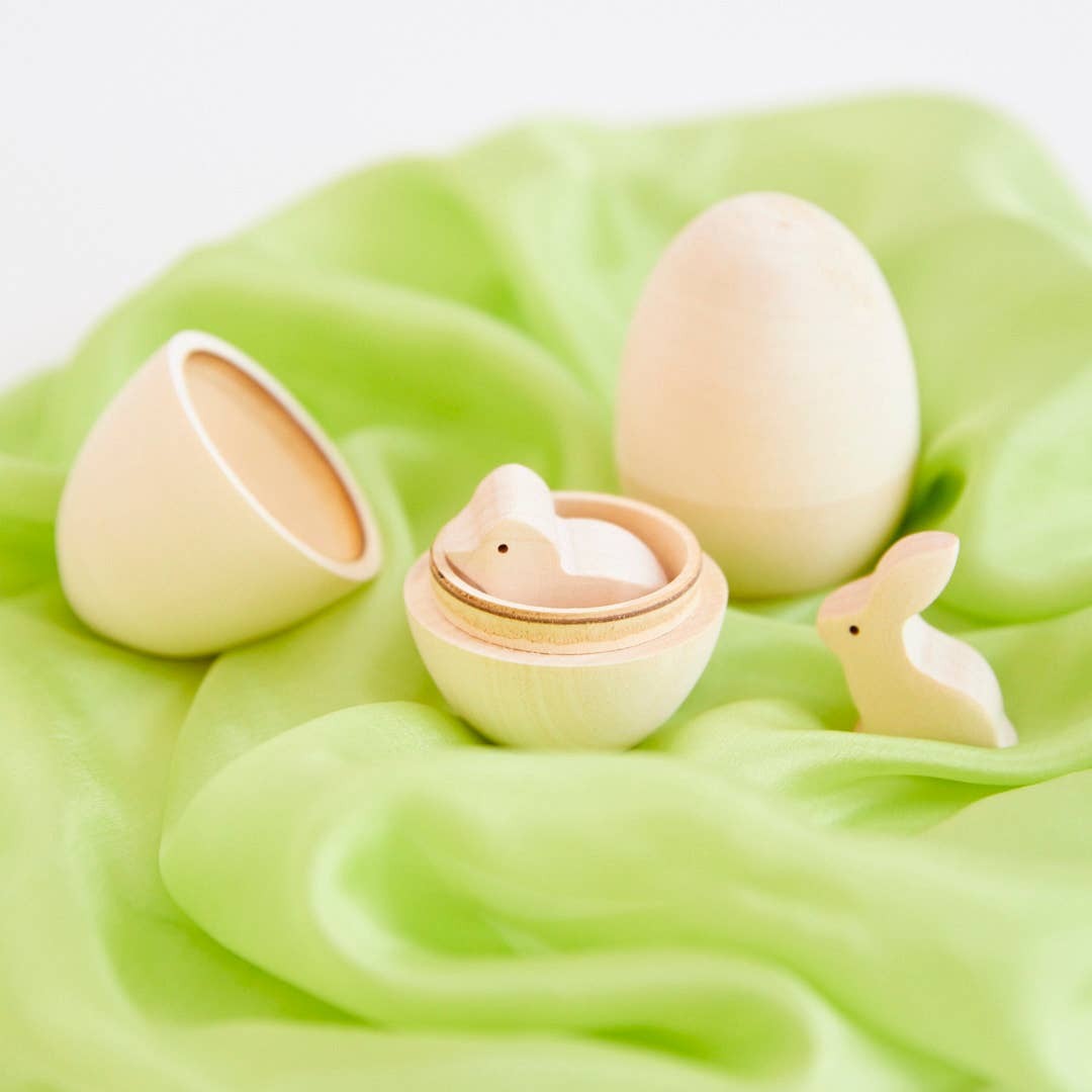 wooden eggs on green playsilk