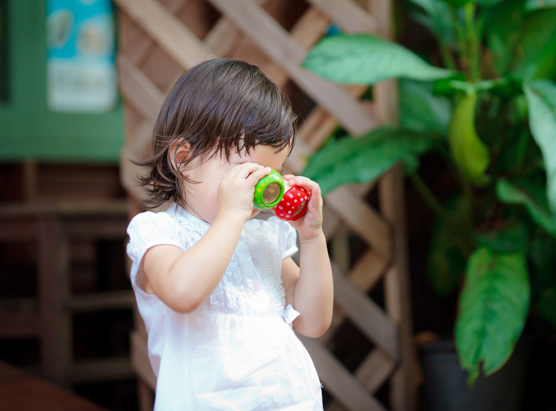 child looking through Mushroom Kaleidoscopes by Plan Toys