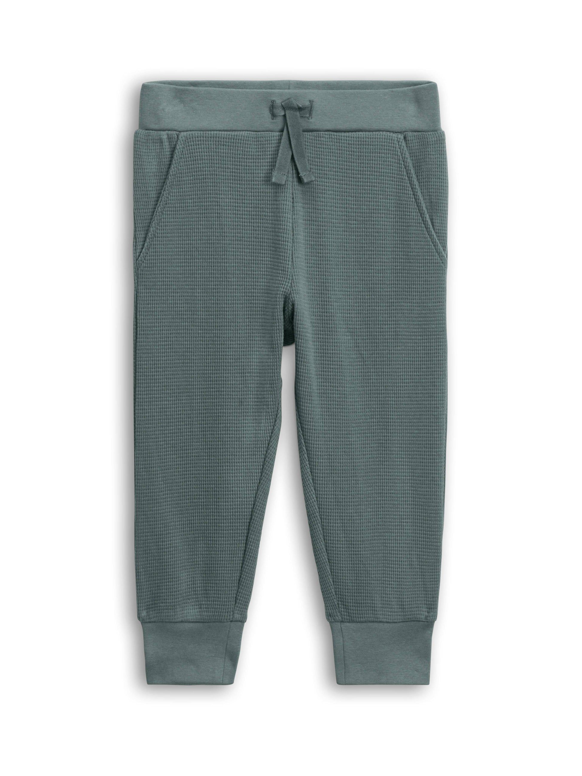 Green textured jogger pants on a white background
