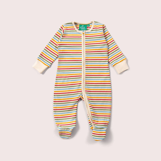 Striped baby romper with a cream and muted rainbow stripes a light gray background