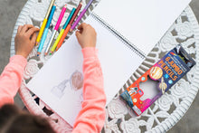 Load image into Gallery viewer, child wearing a pink sweater drawing on a sketchbook
