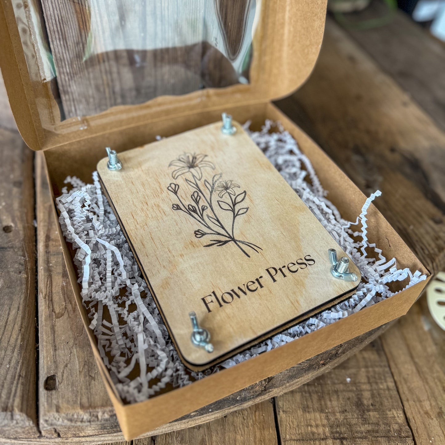 Wooden flower press with 'Flower Press' branding on a wooden surface