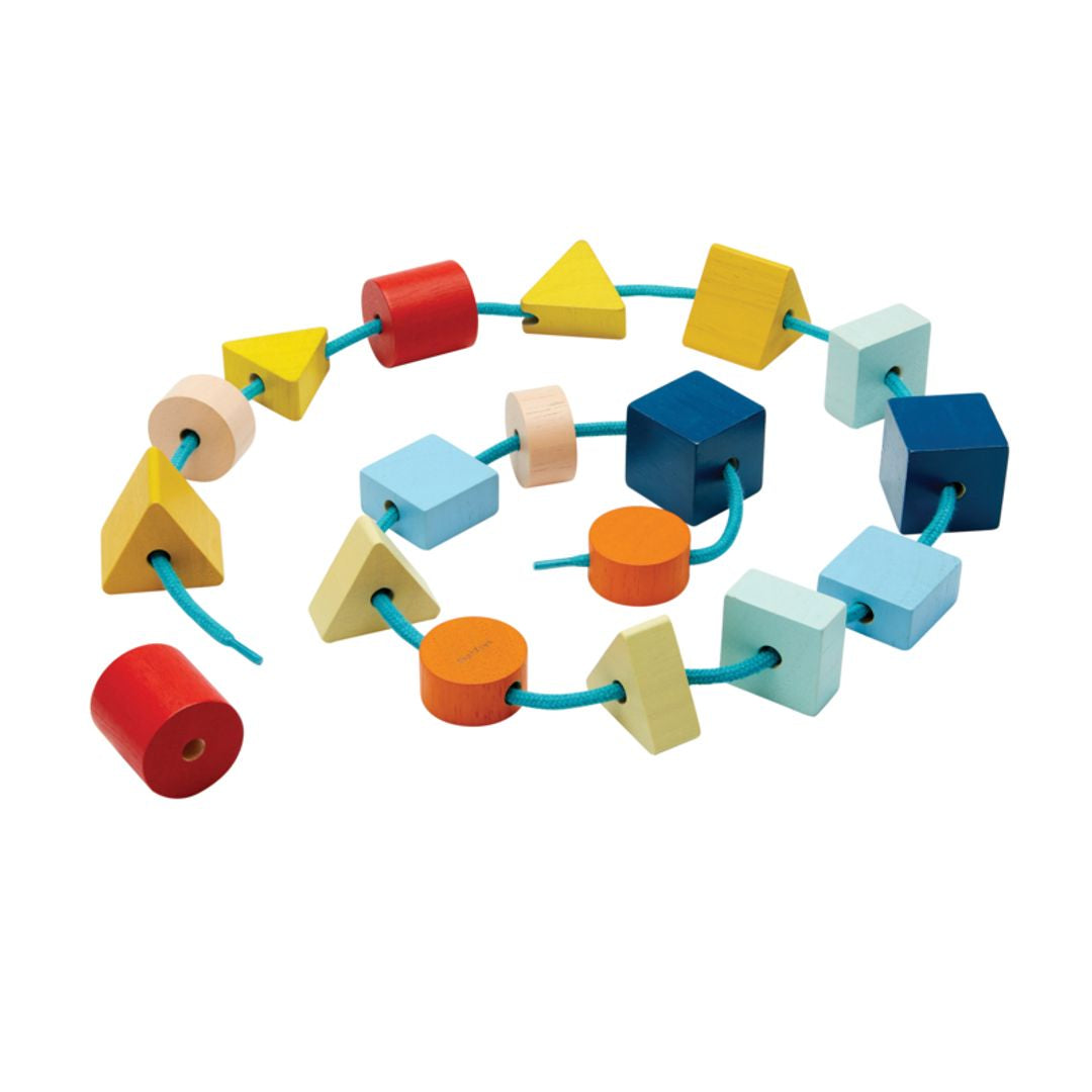 Colorful wooden shape sorter toy on a white background