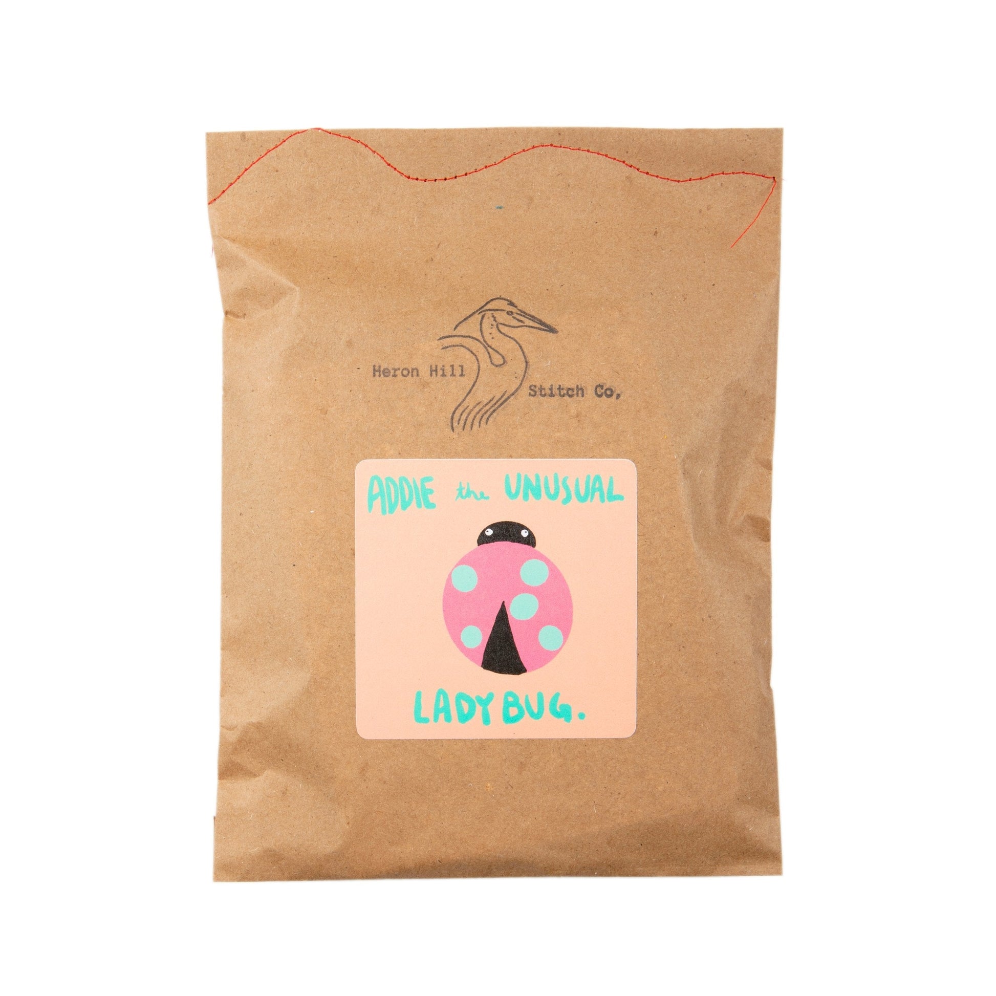 Kraft paper package with a colorful label featuring a ladybug illustration on a white background