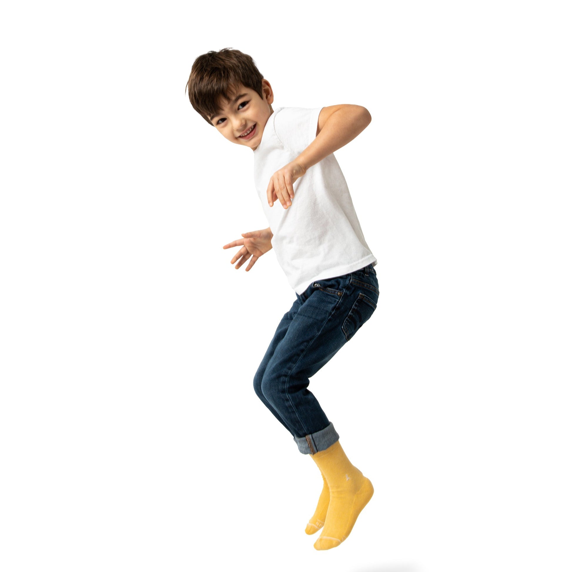 Child wearing a white t-shirt, blue jeans, and yellow socks on a white background