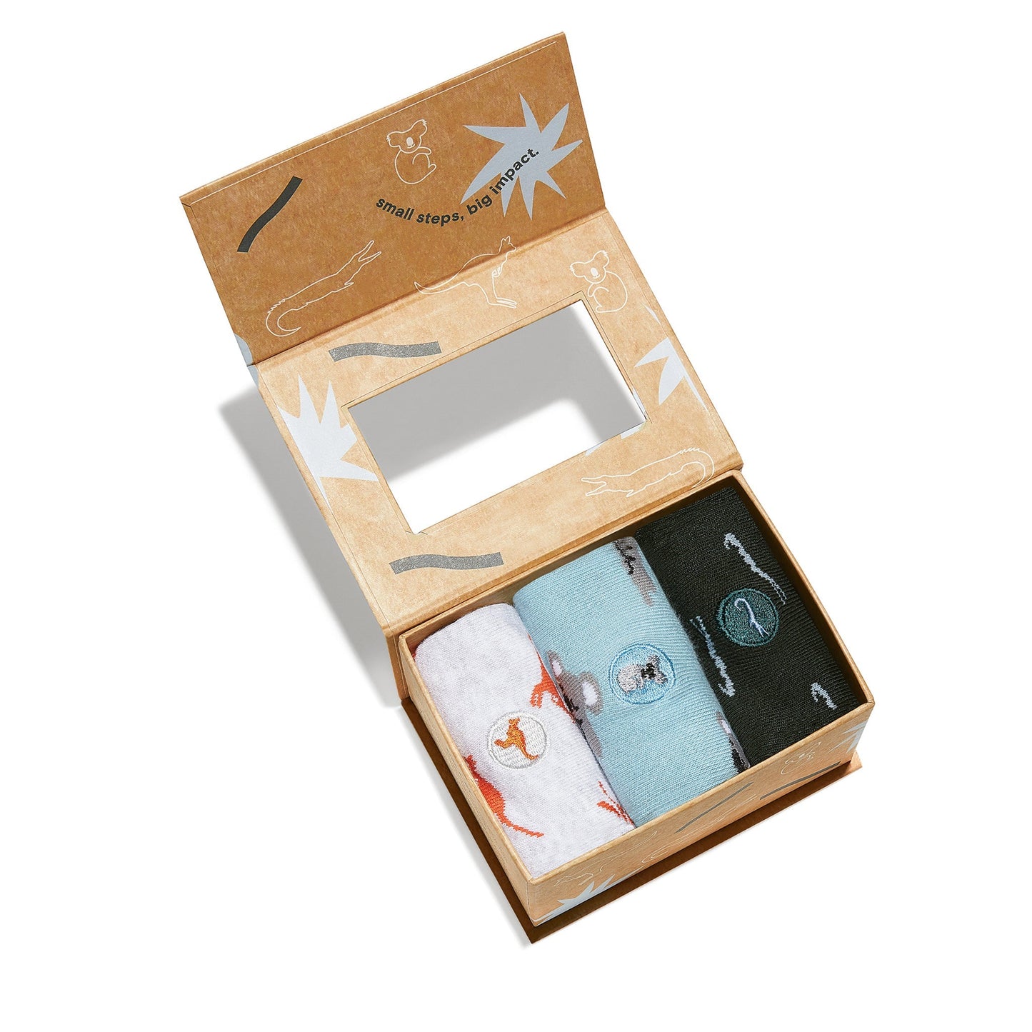 Three pairs of socks in a decorative box with visible branding on a white background