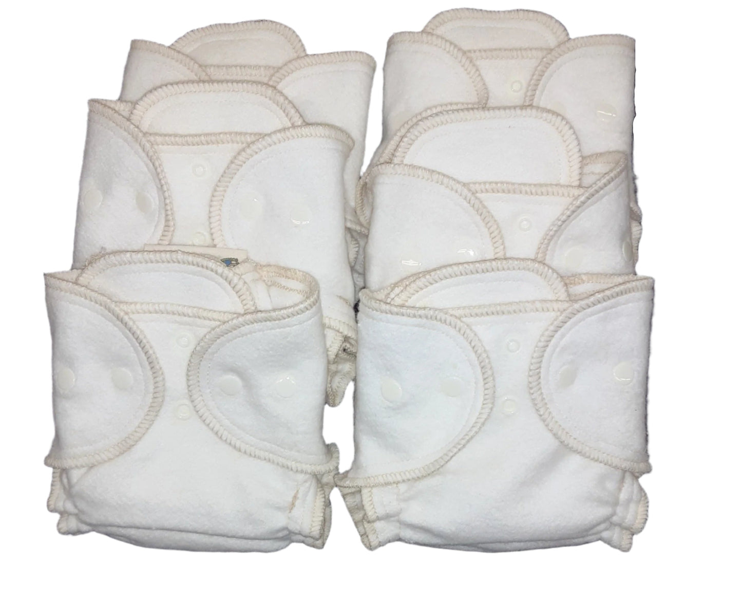 Set of white cloth diapers with snap closures on a white background
