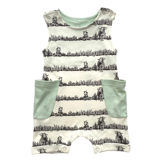 Baby romper with cow print and green accents on a white background