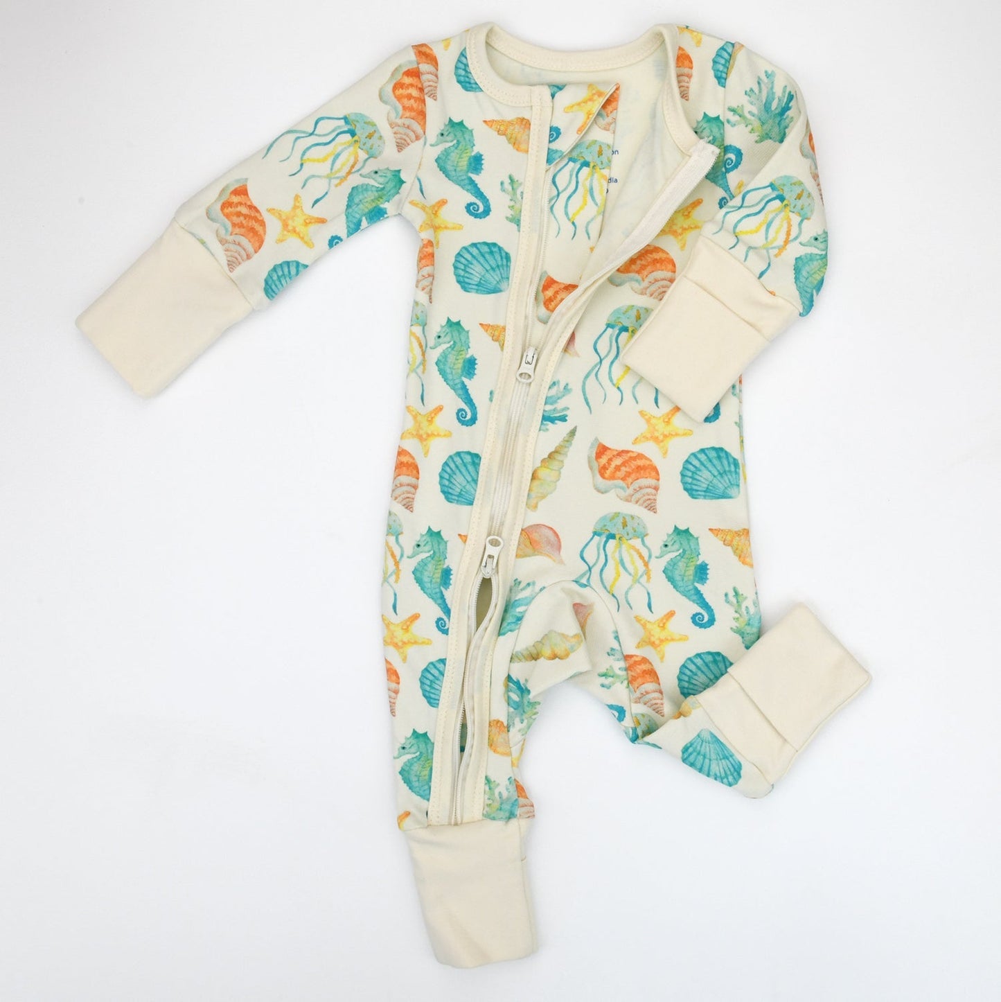 Baby onesie with seahorse and shell pattern on a white background