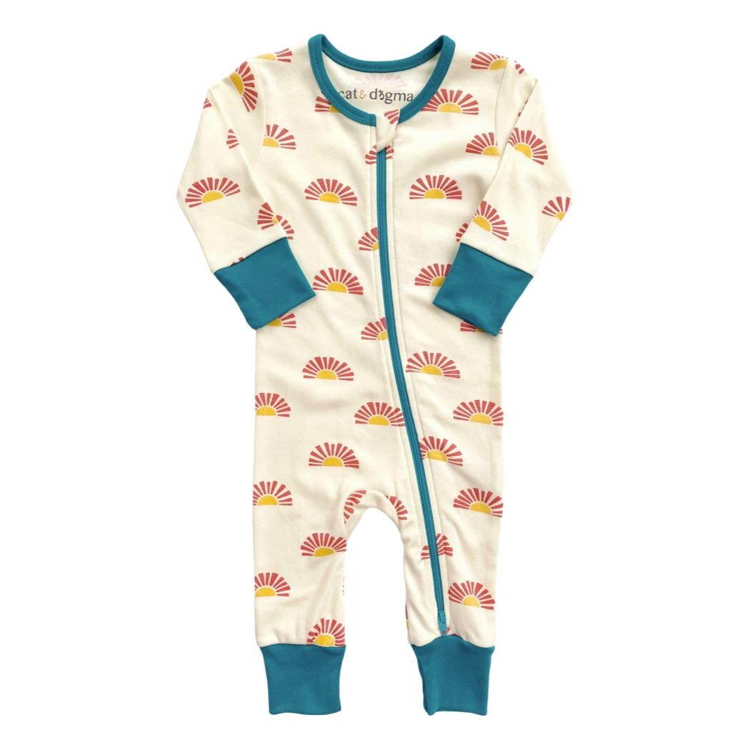 Children's onesie with sun pattern and blue accents on a white background