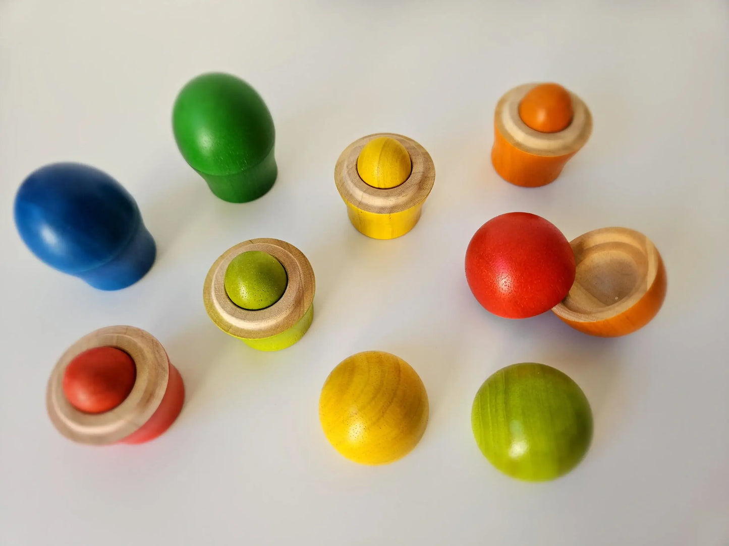 Rainbow colorful wooden sorting eggs an cups on a white back ground Sorting_Egg_Cups