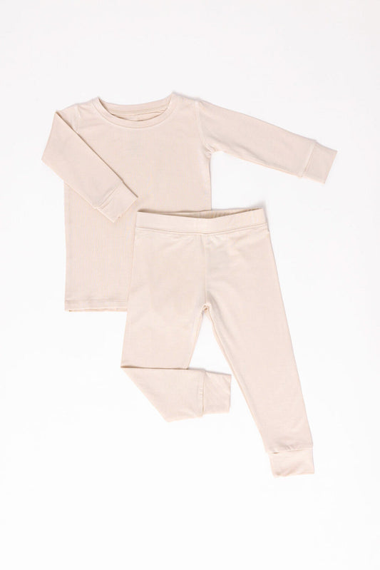 Beige long-sleeve top and pants set on a white background