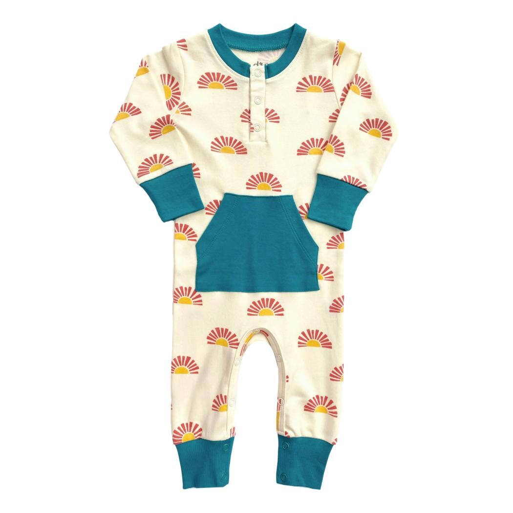 Children's onesie with sun pattern and blue accents on a white background