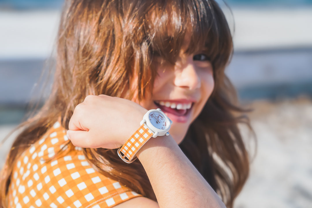Woman wearing a smartwatch with a colorful strap outdoors