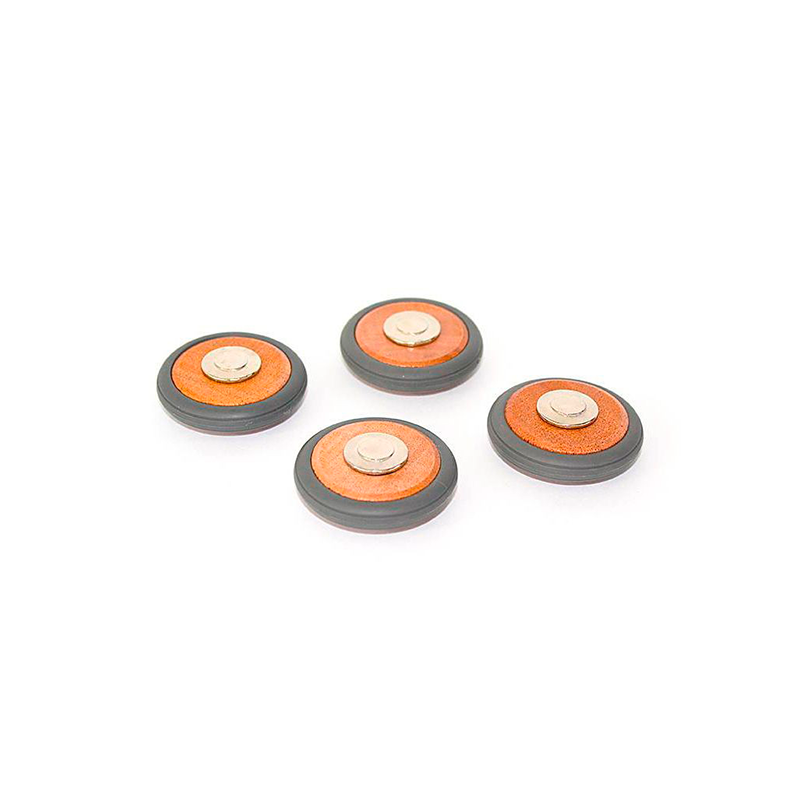 Four round objects with orange centers and gray bases on a white background