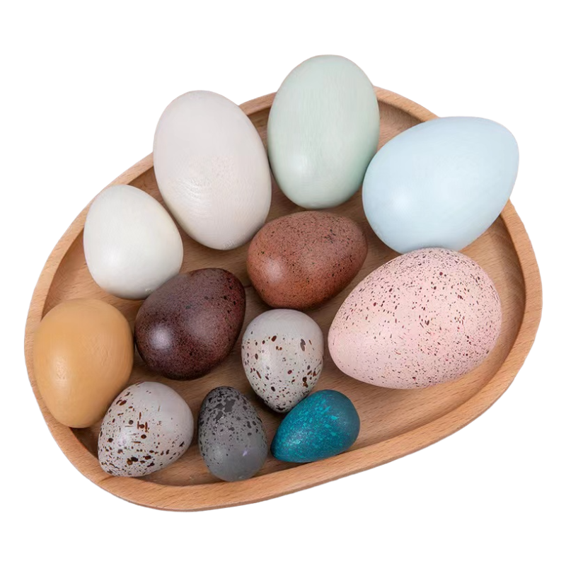 Wooden bowl with colorful speckled eggs on a white background