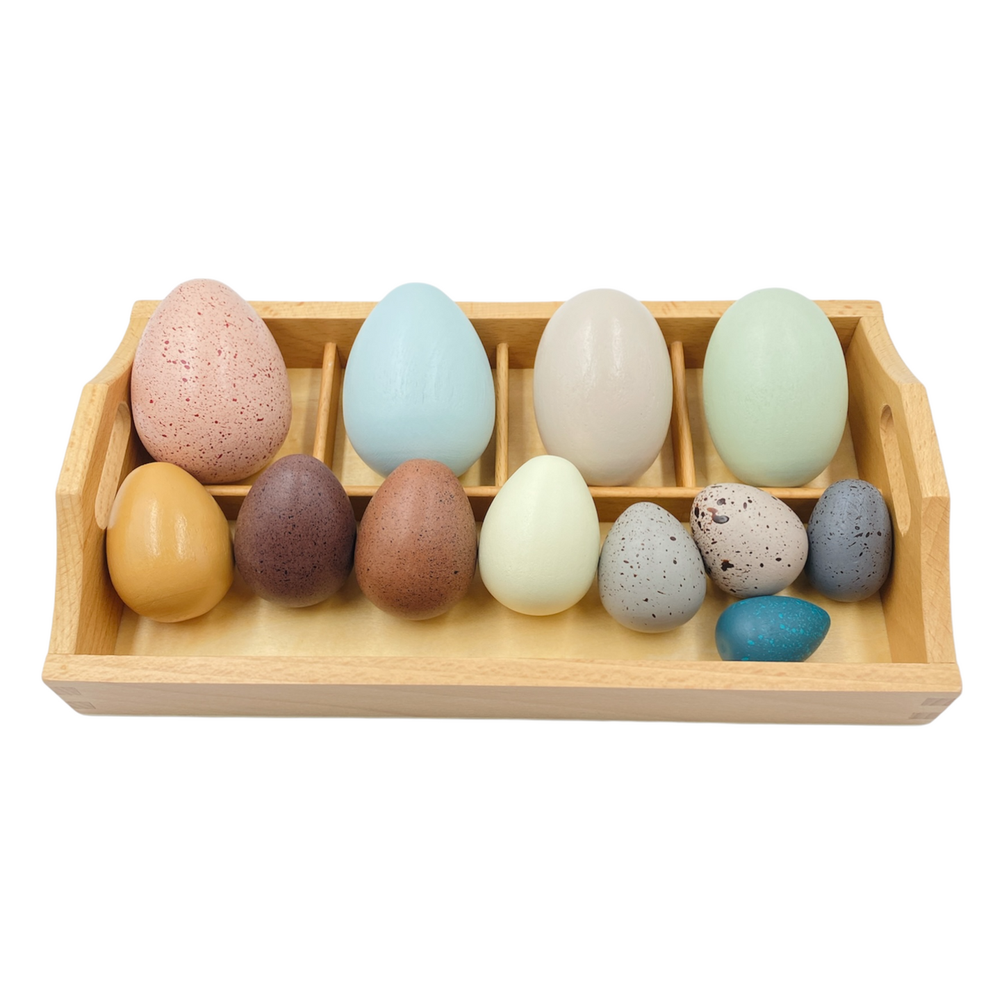 Set of colorful wooden eggs in a wooden tray on a white background
