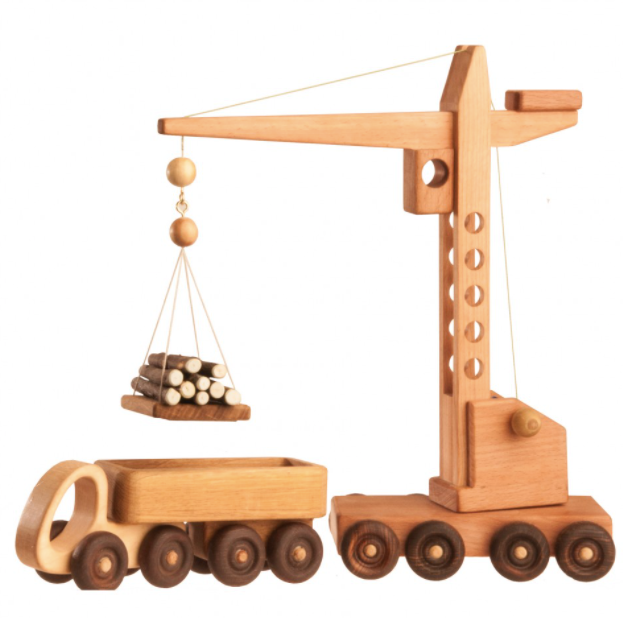 Wooden toy crane with truck and logs on a white background