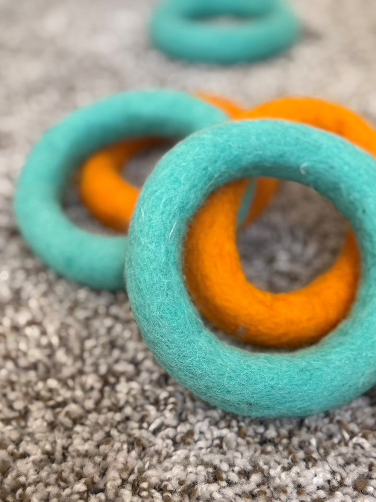 Turquoise and orange rings on a textured surface