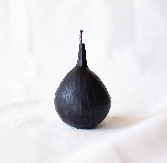 Black pear-shaped candle on a white background