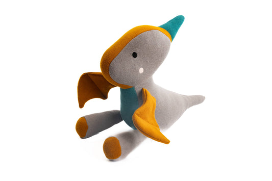 Toy patchwork pterodactyl on a white background