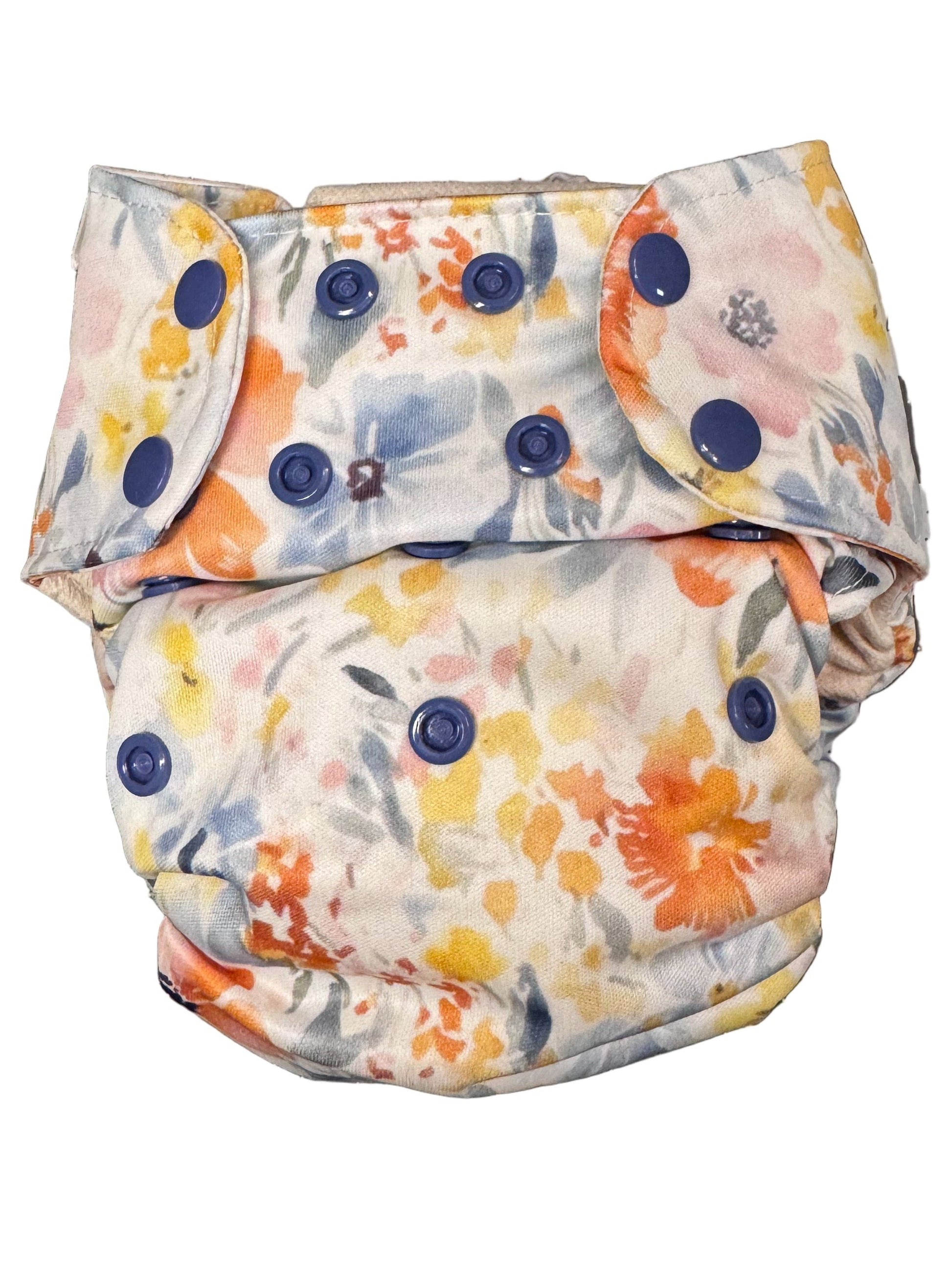 Floral-patterned diaper with blue buttons on a white background