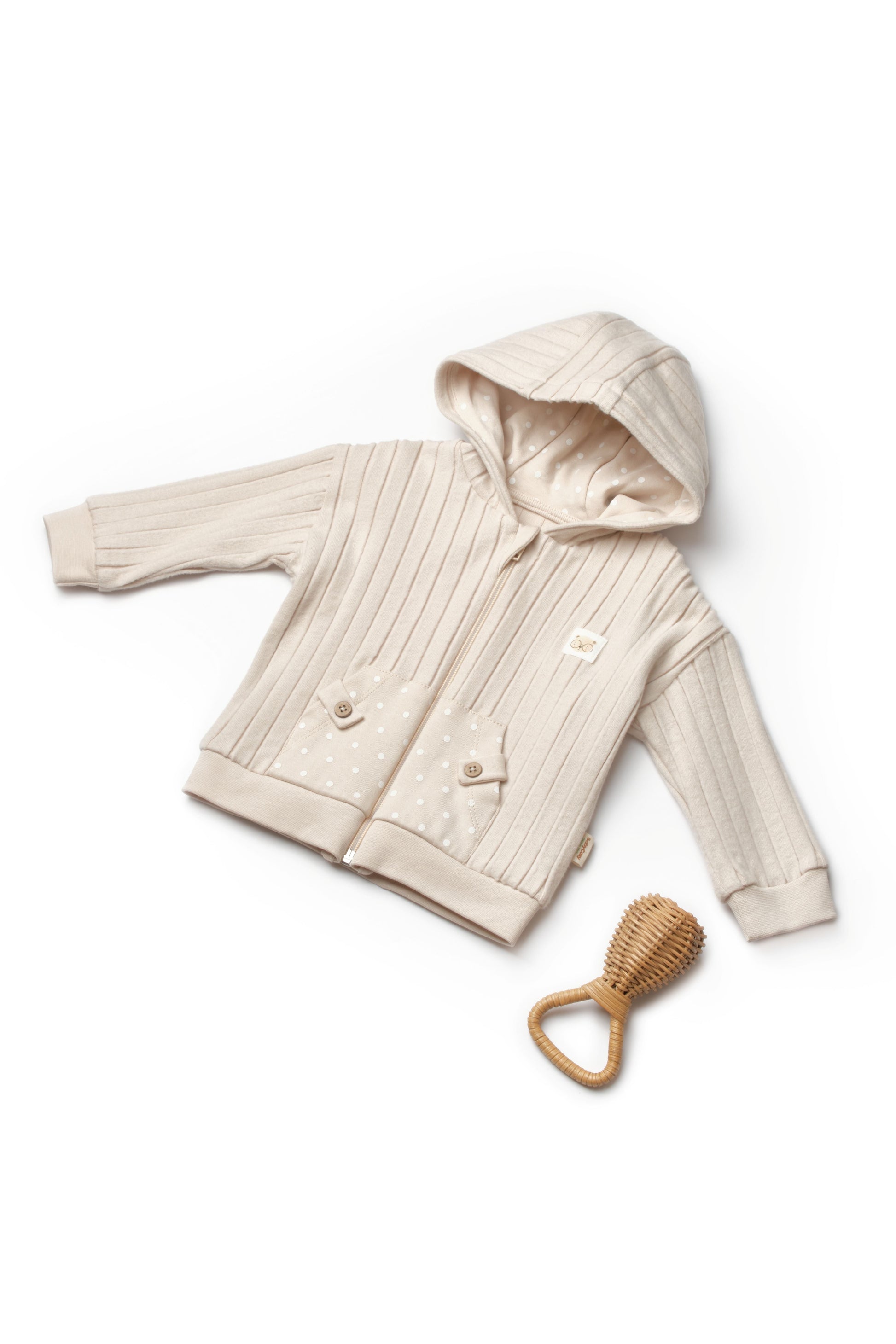 Beige baby jacket with hood and wooden teething ring on a white background