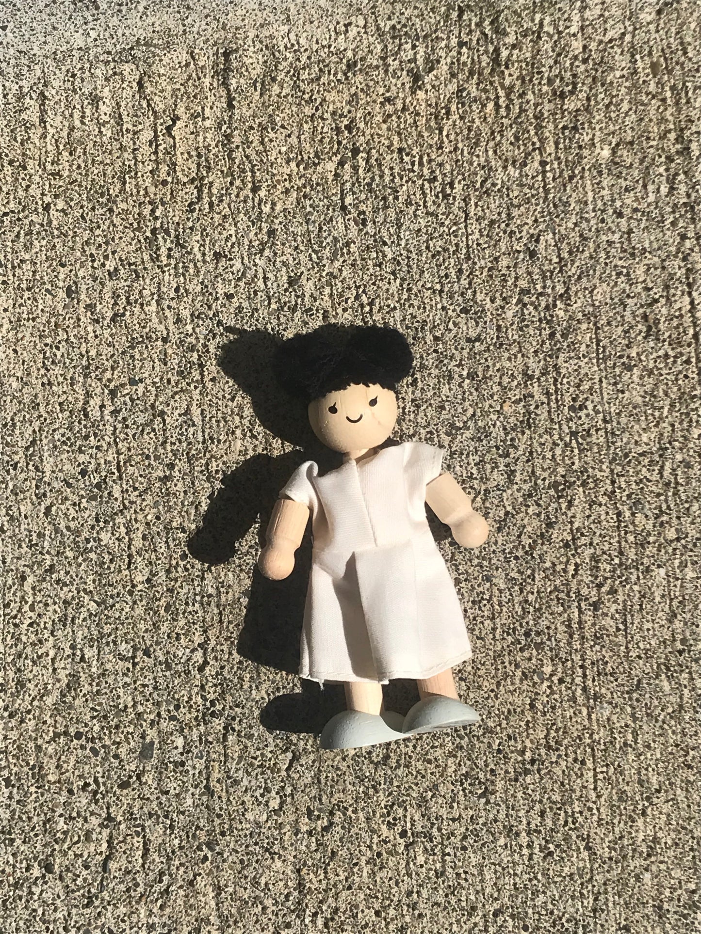plan toys doll in a white dress