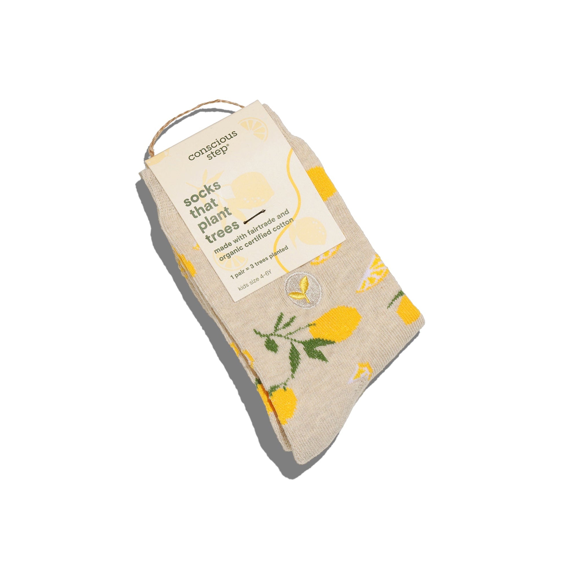 Beige socks with yellow lemon design and 'Conscious Step' label on a white background