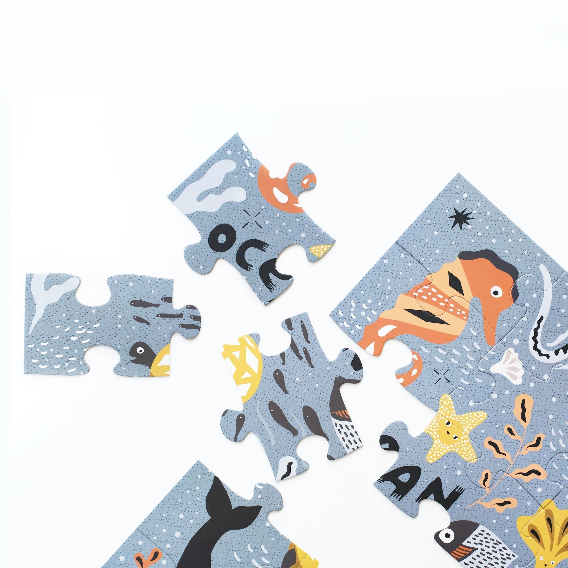 Children's puzzle with ocean-themed pieces on a light blue background