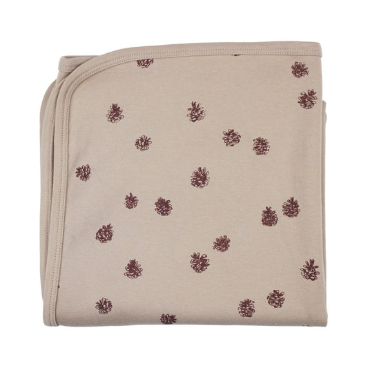 Beige folded baby blanket with pinecones  pattern on a white background