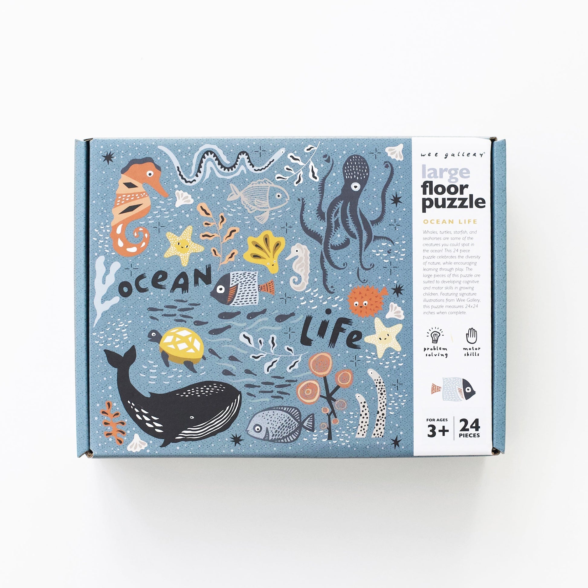 Box of a large floor puzzle with ocean-themed illustrations on a white background