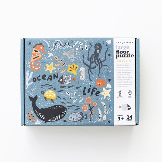 Box of a large floor puzzle with ocean-themed illustrations on a white background