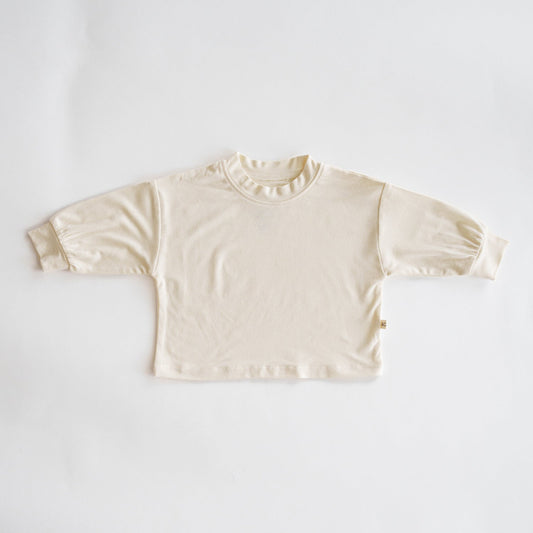 Beige long-sleeve shirt on a white background