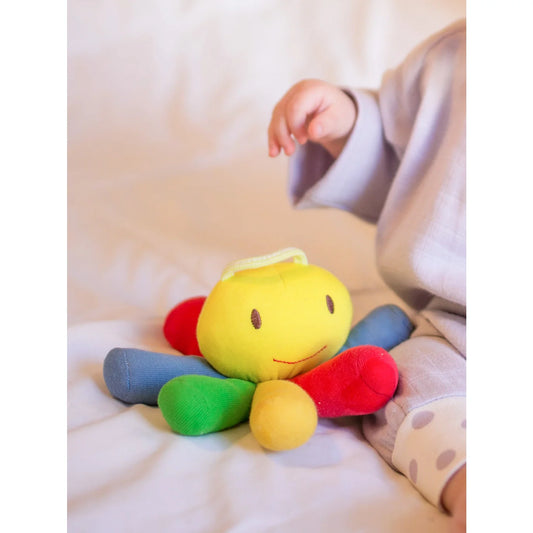 Baby with a Scratopus baby toy