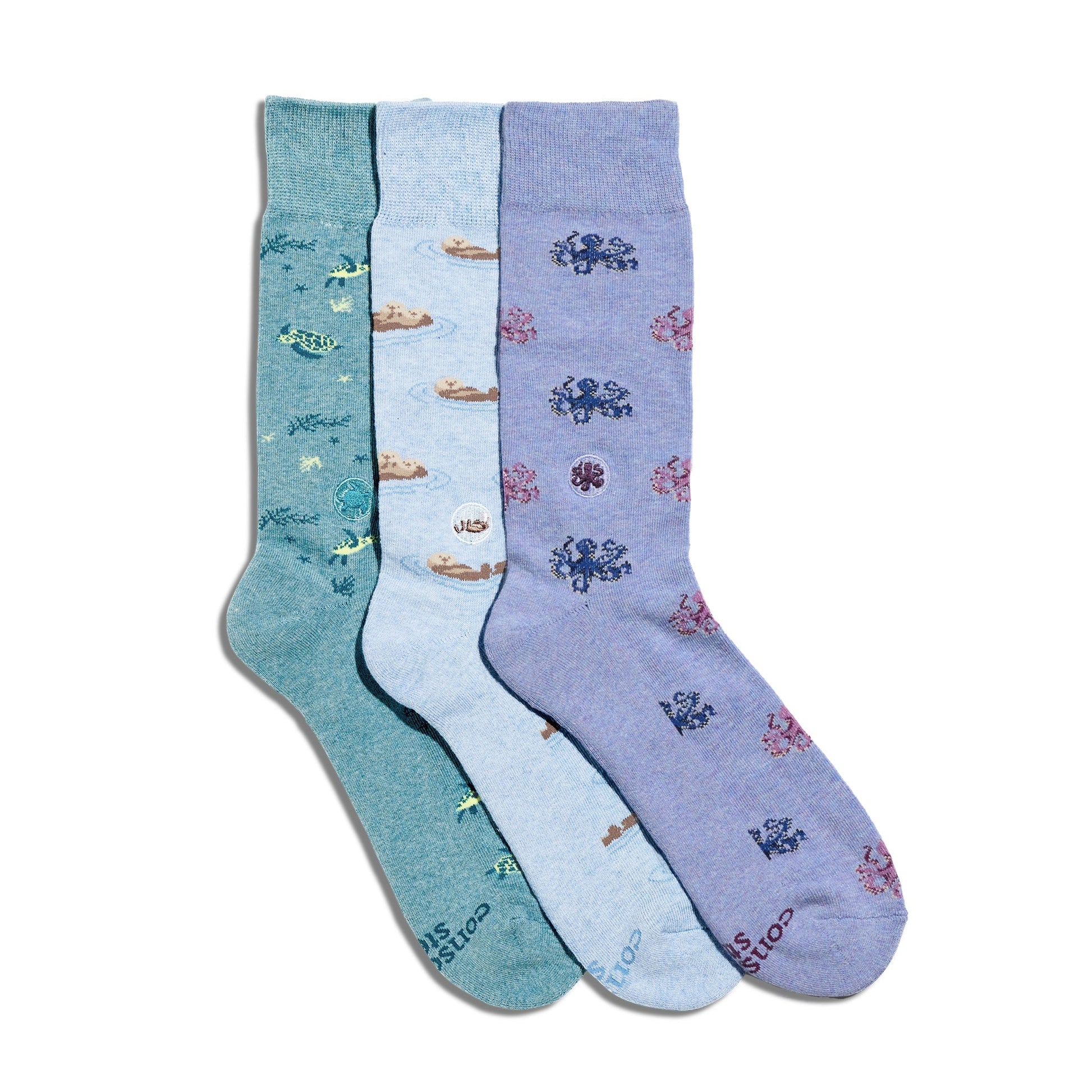 Three pairs of socks in green, blue, and purple with patterns on a white background