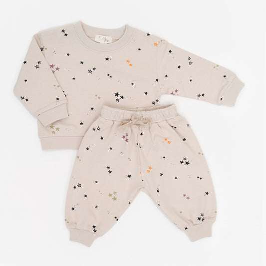 Beige baby outfit with star pattern on a white background
